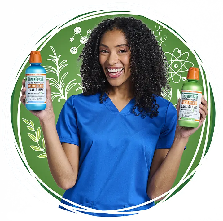 A dental hygienist holding two bottles of TheraBreath&trade; oral rinse
